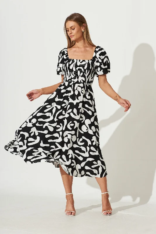 Maxi - inspired midi dresses with flowing fabrics for a beachy vibeMariam Midi Dress In Black With White Print Maxi - inspired midi dresses with flowing fabrics for a beachy vibeMariam Midi Dress In Black With White Print